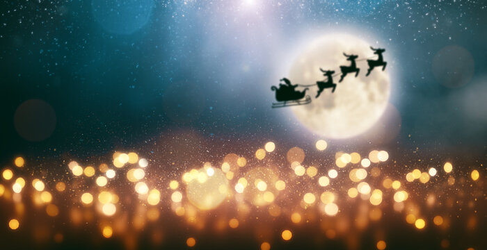 Santa Claus is flying on a sleigh pulled by reindeer