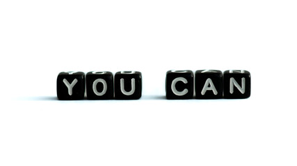 You can motivation quote made of black letter beads on white background. Inspirational speech.