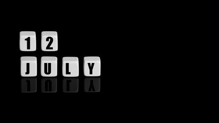 July 12th. Day 12 of month, Calendar date. White cubes with text on black background with reflection. Summer month, day of year concept
