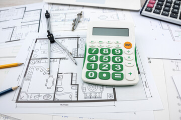 Building plans drawing with helmet and drawing tools.