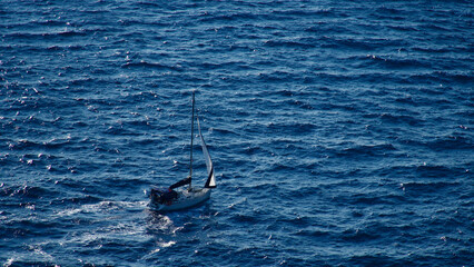 Fototapeta premium Cargo ship at sea. transit ship. Sailboats. Fishing boat. Fishing ship. Sightseeing Boat. Boat, ship floating in blue waters. Sunburns and ship reflecting from the sea.