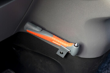 Safety hammer mounting and seatbelt cutter install inside a car use next to driver seat. A tool to help passenger to escape in case of emergency accident.