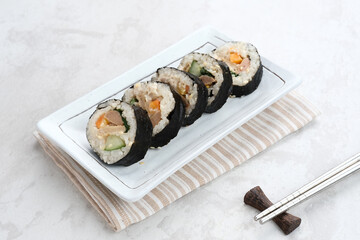 Korean Rolled Gimbap, made of rice, cucumber, tuna, carrot, sausage, crab stick and wrapped with seaweed laver. 
