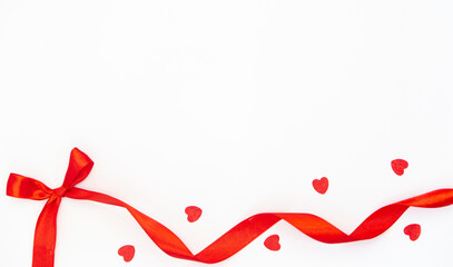 Red ribbon bow on white background isolated, flat lay.