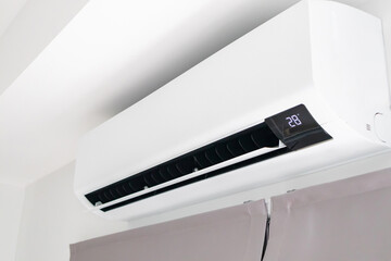 Air conditioner on white wall room interior background