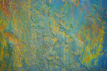 Old rusty painted metal wall. Blue green yellow orange abstract background for design. Rust. Strokes, spots. Grunge. Colorful rough surface. Damaged, distressed.