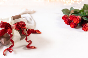 Festive background with a gift box and a bouquet of roses on a white background.