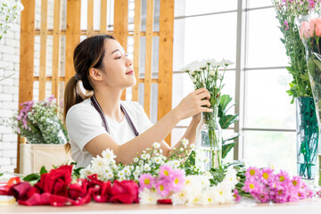 group of female florists Asians are arranging flowers for customers who come to order them for various ceremonies such as weddings, Valentine's Day or to give to loved ones.