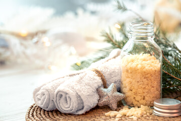 Winter spa composition with body care items and decor details.