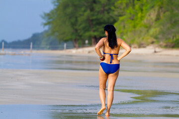 Fototapeta premium Woman body big walk exercise with swimsuit in morning