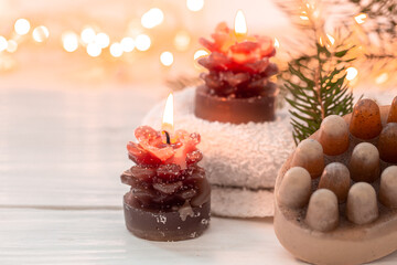 Christmas spa composition with incense sticks and soap on a blurred background.
