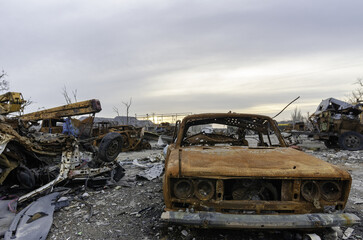 Fototapeta premium burnt cars and destroyed buildings of the workshop of the Azovstal plant in Mariupol