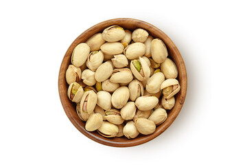 Pistachio nuts in wooden bowl on white background
