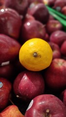 Fresh lemon with red apple background 