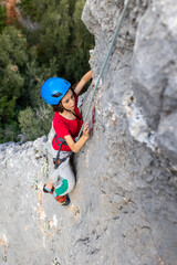 Fototapeta premium climber boy. the child trains in rock climbing.