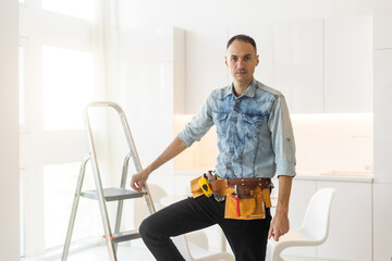 handyman with tool belt with construction tools