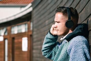 young man with headphones on the street