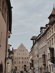 Old historic architecture in Nuremberg, Germany. Traditional European old town buildings with wooden windows, shutters and colourful pastel walls. Aesthetic summer vacation, tourism background