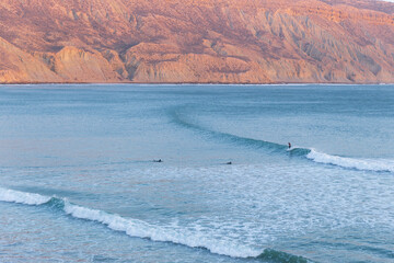Longboard surfers on the beach at the longest wave of North Africa at Imsouane, Morocco