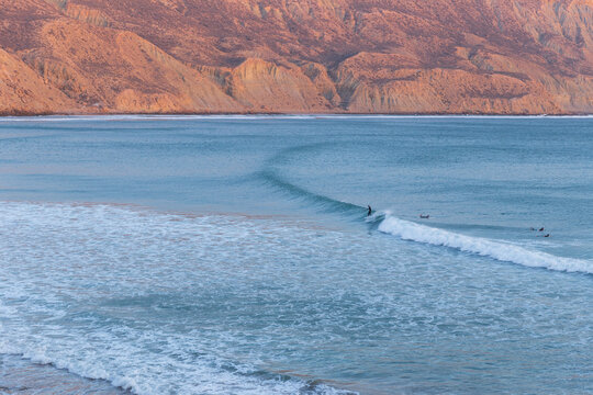 Longboard surfers on the beach at the longest wave of North Africa at Imsouane, Morocco