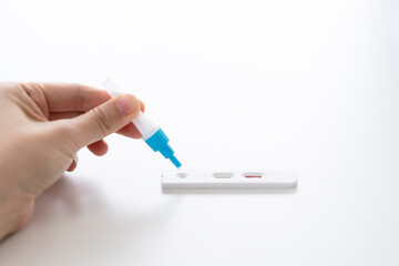 woman holding a rapid antigen test kit