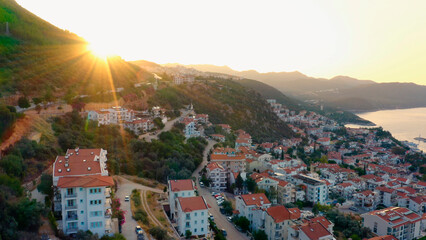 Sunrise over beautiful cityscape. City buildings, country road and mountains. Vacation at Turkey.