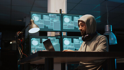 IT criminal hacking system at night using virus to produce computer malware and server error. Data...