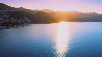 Aerial panoramic view of beautiful resort town on Mediterranean coast at sunset. Vacation concept.