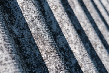 Close-up of shingles, slate roof. Abstract gray background with wavy texture. External design of the building. Roofing banner texture, background for roofing banner. Copy space, space for text