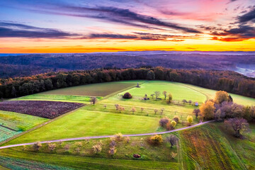 Germany, Baden-Wurttemberg, Drone view of countryside fields in Swabian-Franconian Forest at autumn sunrise