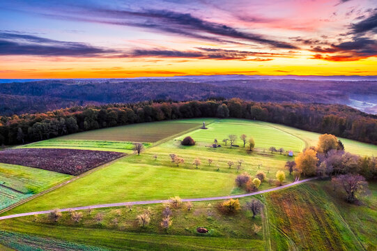 Germany, Baden-Wurttemberg, Drone view of countryside fields in Swabian-Franconian Forest at autumn sunrise