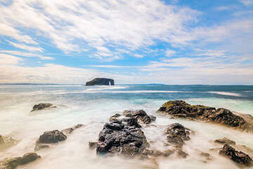 UK, Scotland, Rocky shore of Northmavine with Dore Holm arch in background