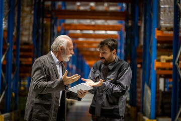 Fototapeta na wymiar Warehouse manager and worker arguing about some errors done in work