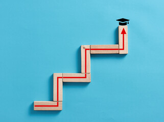 To get a diploma, degree and graduation in education concept. Wooden blocks stacking as step stair...