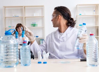 Two chemists working in the lab