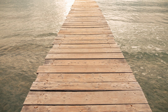 Jetty amidst sea at sunset