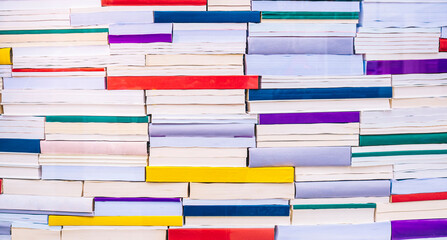 Full frame of colorful books stacked on each other at store