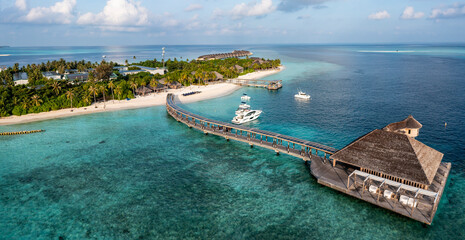 Aerial view of sea with tourist resort under cloudy sky at Maldives