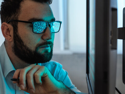 Programmer with beard hacking computer through virus