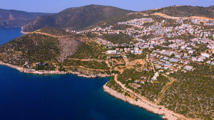 Picturesque aerial view of mountains with beautiful townscape and sea bay. Alpine coastal town from above.