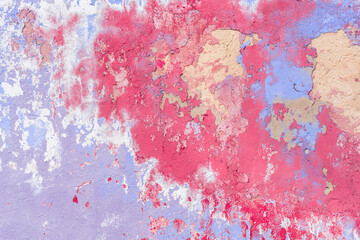 Weathered painted wall background texture. Old shabby peeled plaster wall with falling off flakes of colourful paint. 1