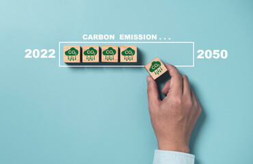 Man holding CO2 reducing icon with virtual loading for decrease CO2 , carbon footprint and carbon...