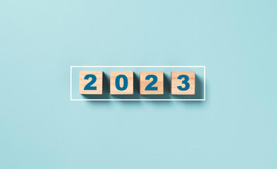 Businessman array wooden cube block with virtual loading bar for count down from 2022 to 2023 year of preparation merry Christmas and happy new year by technology download concept. - obrazy, fototapety, plakaty