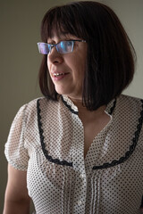Portrait of a cute middle-aged brunette woman in glasses.