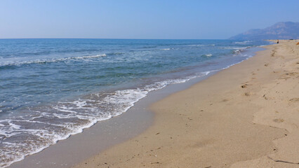 Fototapeta na wymiar Blue sea waves on sandy beach. Nature background. Sea vacation concept.