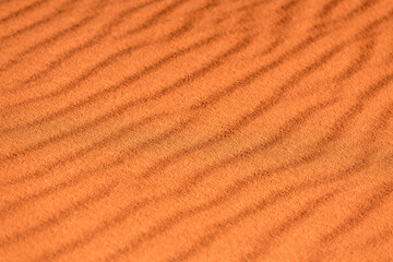 Gold orange desert sand texture background with waves and traces