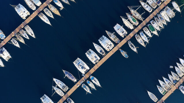 Top view of boats on blue water surface. Summer seascape from above. Travel and sea voyage concept.