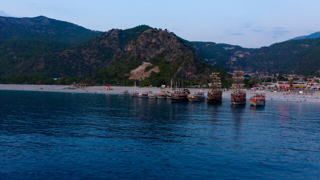 Beautiful aerial view from the sea to Kas coast and resort town. Green rocky mountains in the background.