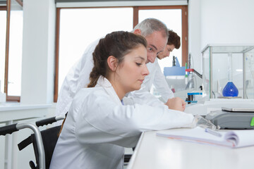 disabled woman in wheelchair working at the lab