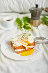 Breakfast on white bed sheets, good morning, toast with poached eggs, coffee, flowers, Hotel room early morning, honeymoon